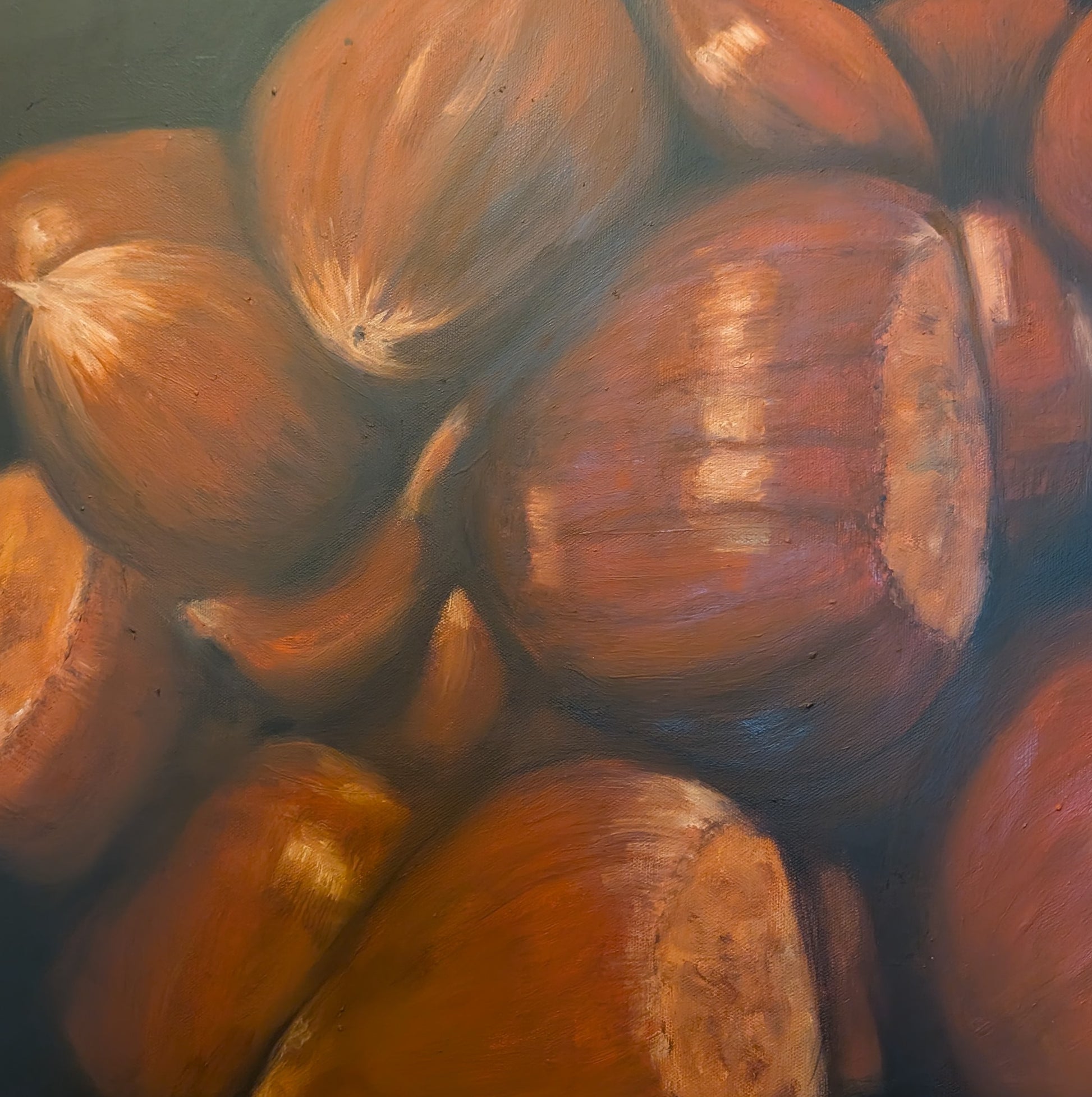 Detail of an oil painting of chestnuts on a dark background